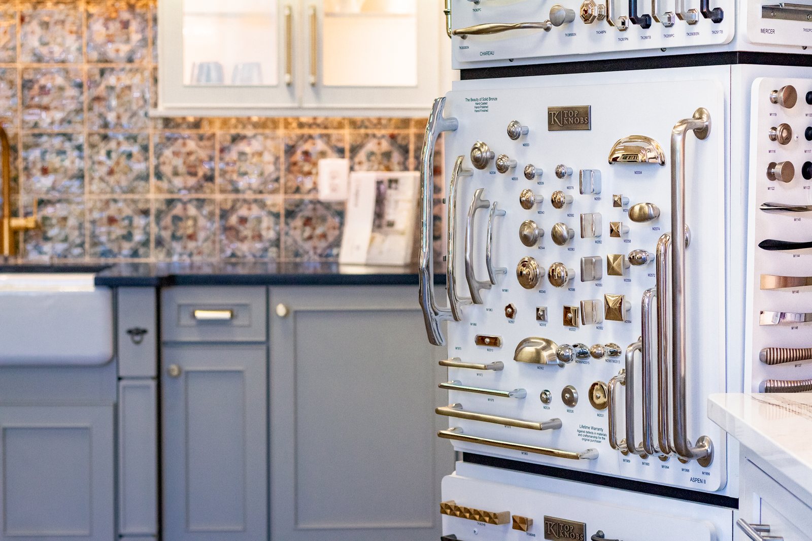 Cabinet hardware display with brass and nickel pulls and knobs