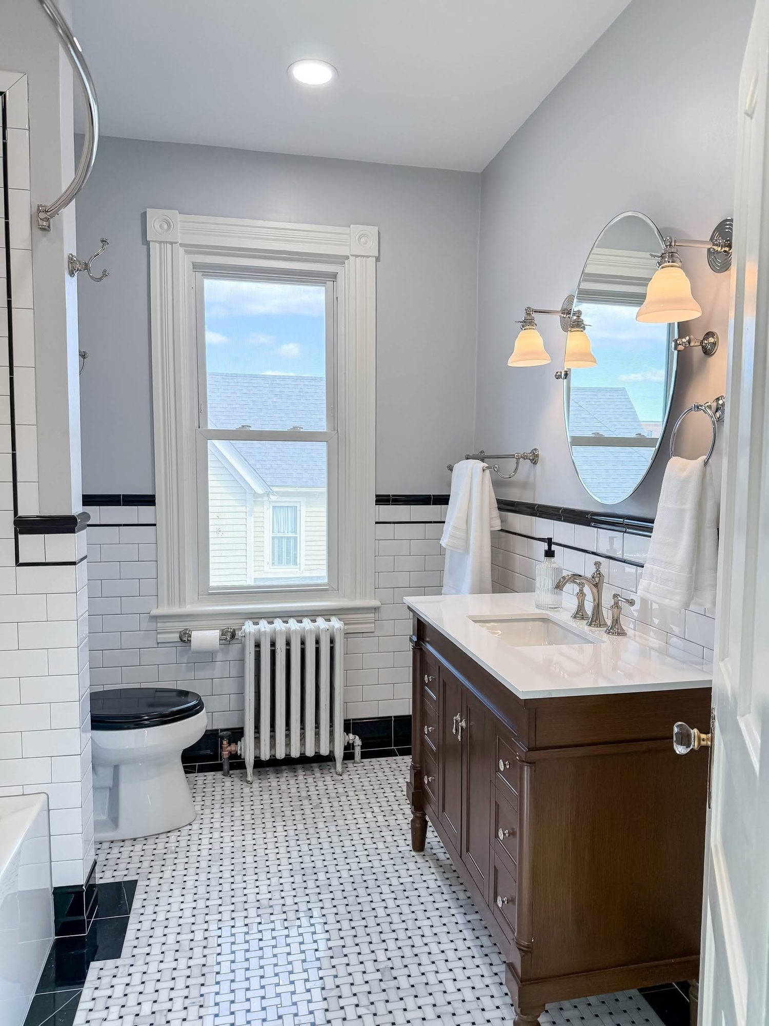 Black and white tile, wood vanity, a bathroom remodel by Sidney Design and Build in Winchester, VA