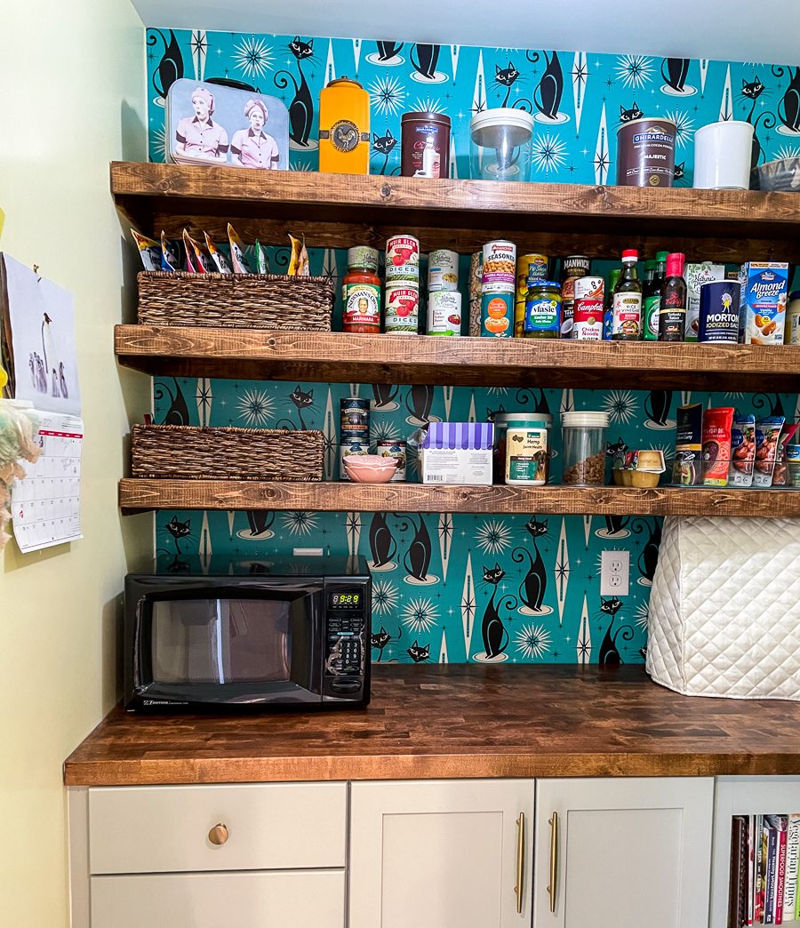Open shelving over a teal backsplash, a kitchen remodel by Sidney Design and Build in Winchester, VA