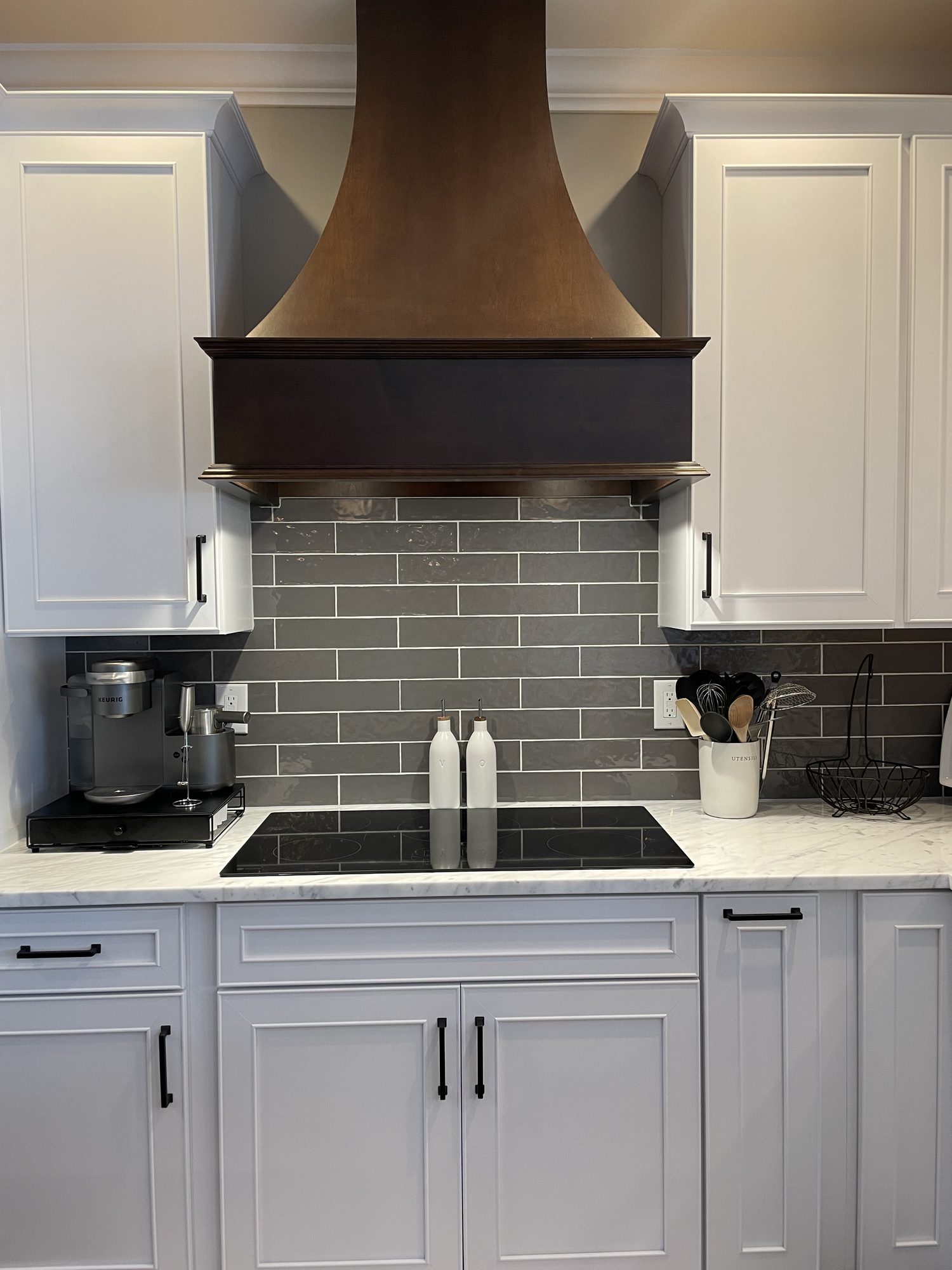 Copper hood over a gray subway backsplash, a kitchen remodel by Sidney Design and Build in Winchester, VA