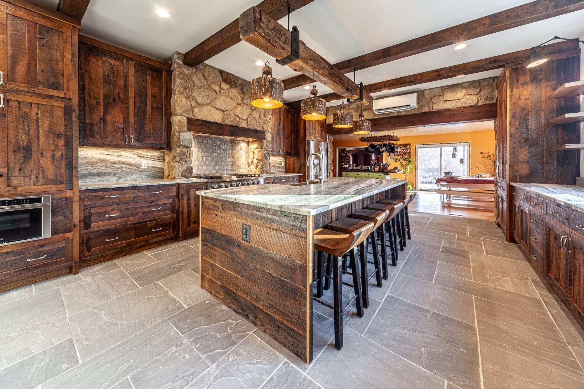 Stone, reclaimed wood and a long island, a kitchen remodel by Sidney Design and Build in Winchester, VA