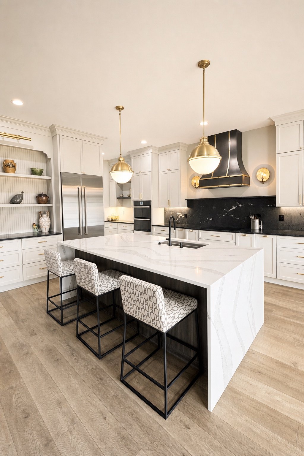 Kitchen remodel with a waterfall island, light painted cabinets, brass pendants and a black and brass range hood, by Sidney Design and Build, Winchester, VA
