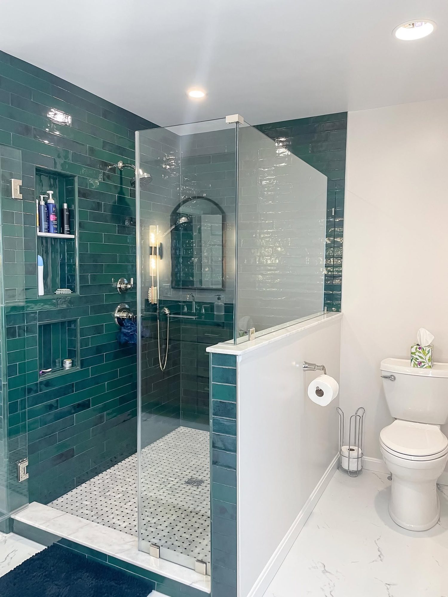 Teal subway tile and glass, a walk in shower by Sidney Design and Build in Winchester, VA