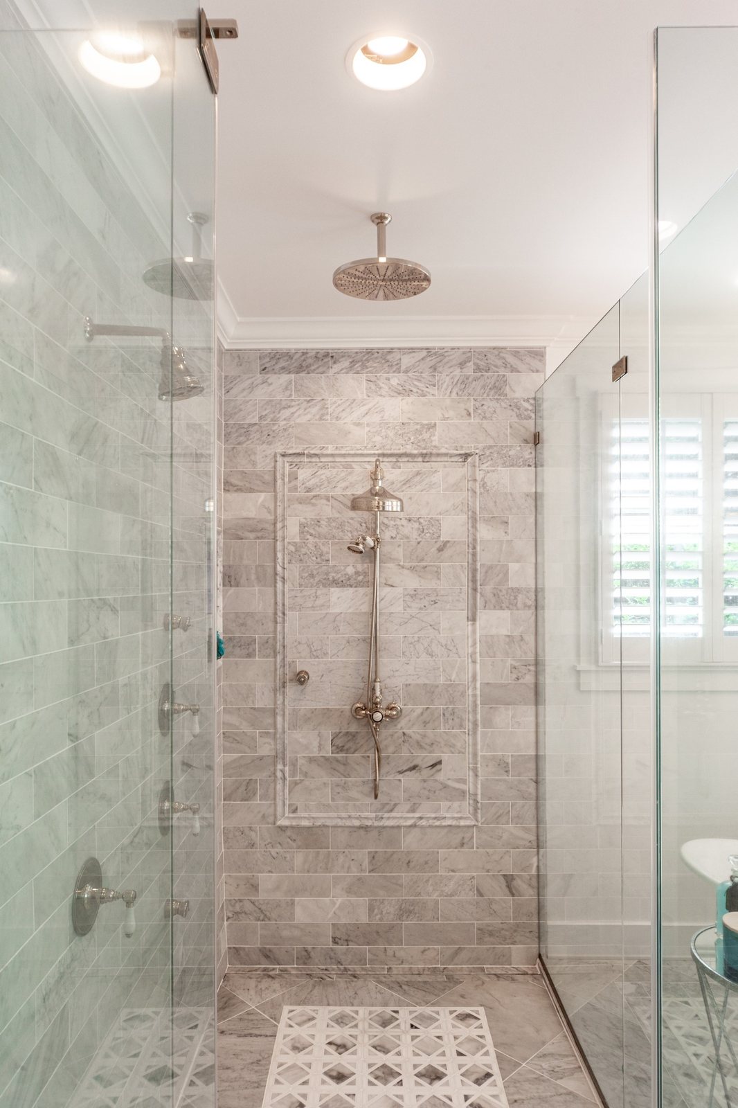 Tiled walk in shower with a mosaic tile floor in a Winchester, VA bathroom finished by Sidney Design and Build